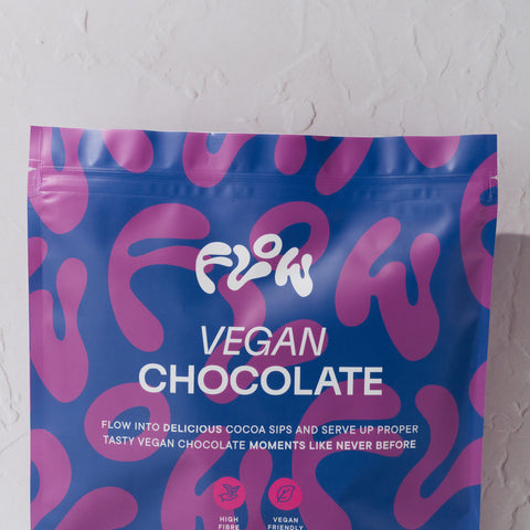 Close-up of the Flow Vegan Chocolate logo and tagline: Flow into delicious cocoa sips and serve up proper tasty vegan chocolate moments like never before