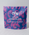 Flow Vegan Chocolate 2kg pouch standing on a black and white grid surface