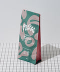 Flow Vibrant Chai 1kg pouch standing on a black and white grid surface