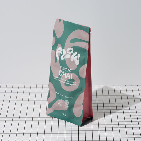 Flow Vibrant Chai 1kg pouch standing on a black and white grid surface