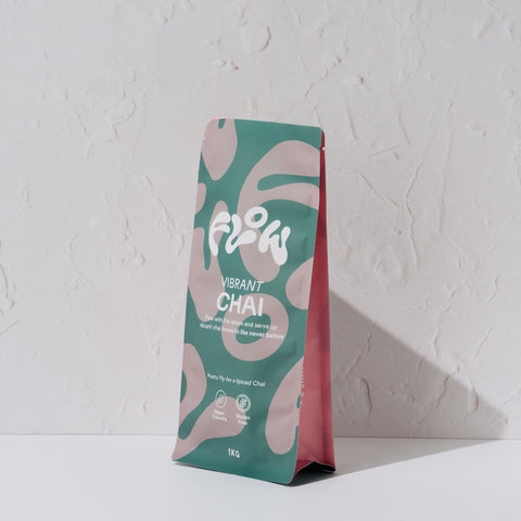 Flow by Blendsmiths Vibrant Chai 1kg pouch at an angle, showing the teal and pink front and pink side gusset