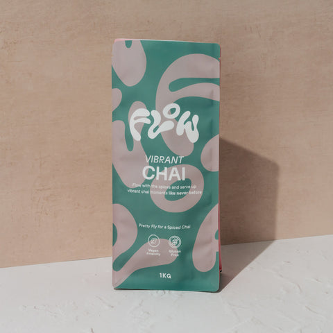 Front view of the Flow by Blendsmiths Vibrant Chai 1kg pouch in teal and pink, reading Pretty Fly for a Spiced Chai, labelled vegan friendly and gluten free