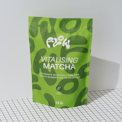Flow Vitalising Matcha 1kg pouch standing on a black and white grid surface